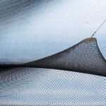 Un filet noir en forme de triangle tendu sous un ciel nuageux